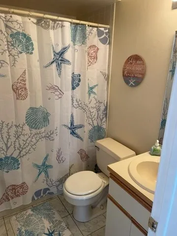 a white toilet sitting next to a bathroom sink