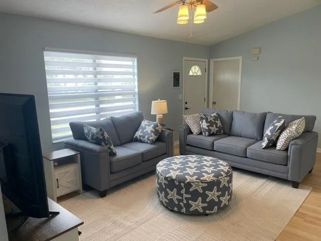 a living room with furniture and a large window