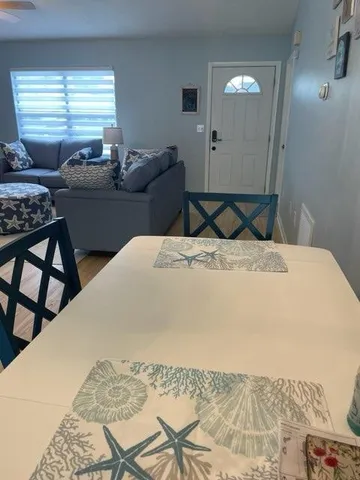 a bedroom with a bed and dresser with mirror