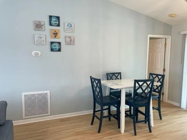 a view of a dining room with furniture and wooden floor