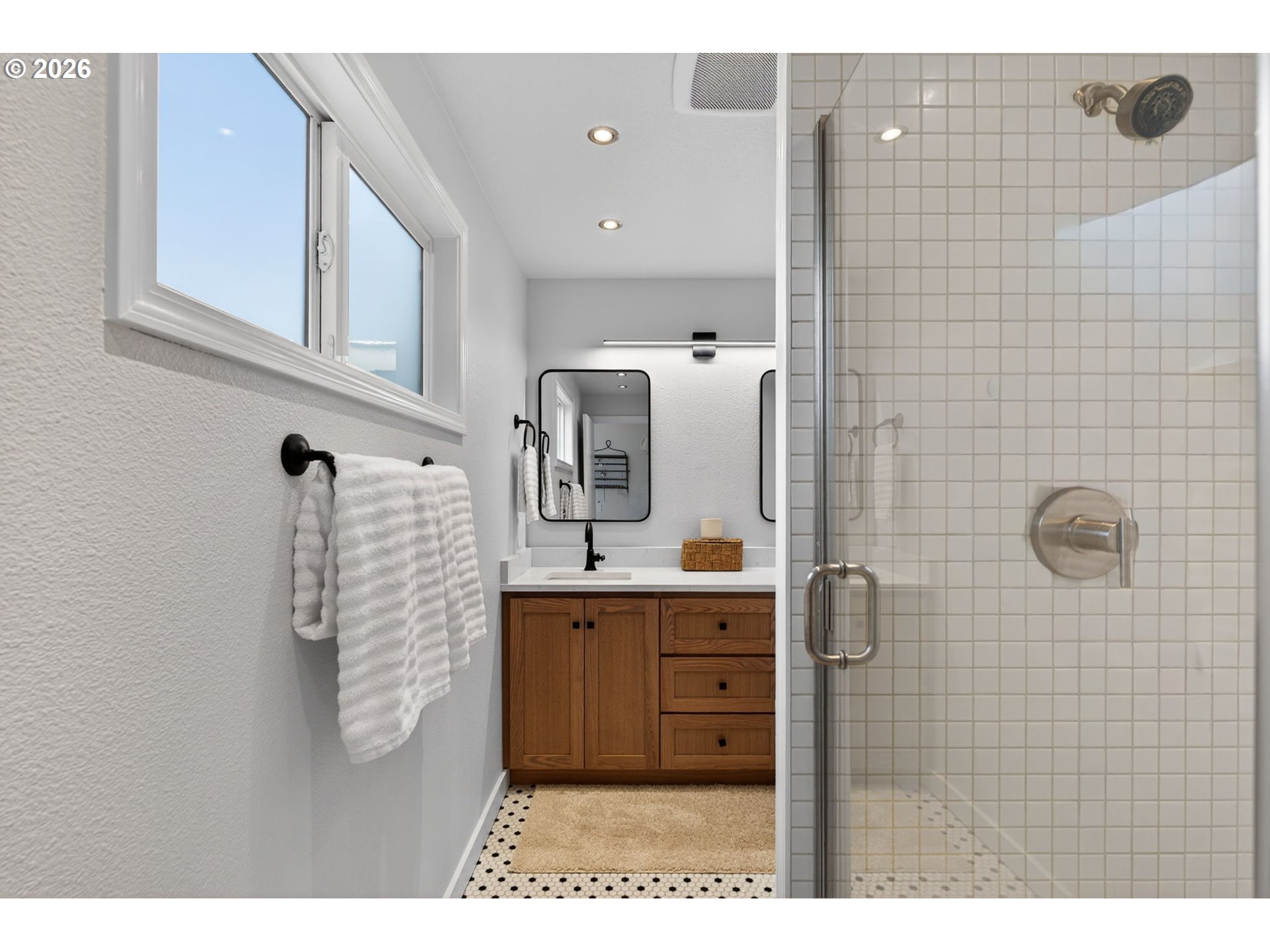 8115 Southwest Hemlock Street Portland, OR 97223 - Photo 17 of 36 a bathroom with a sink a mirror and shower