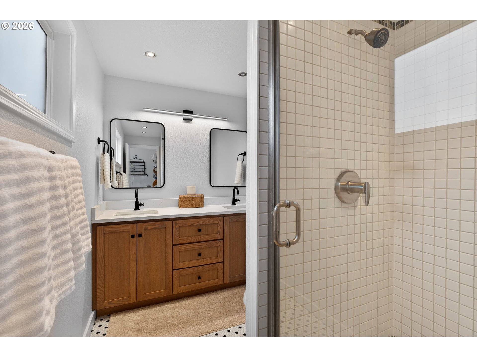 8115 Southwest Hemlock Street Portland, OR 97223 - Photo 18 of 36 a bathroom with a double vanity sink a mirror and shower
