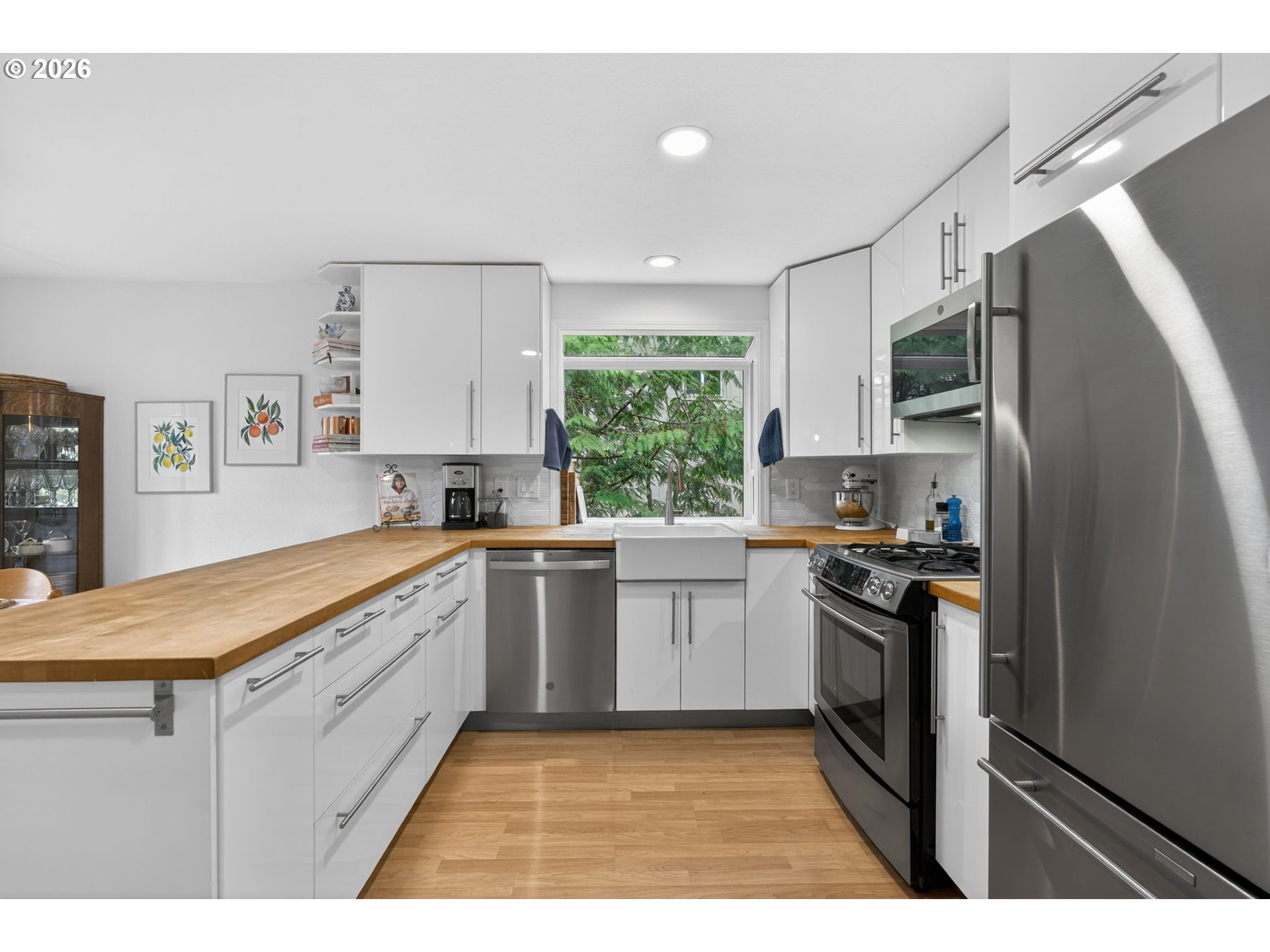8115 Southwest Hemlock Street Portland, OR 97223 - Photo 8 of 36 a kitchen with granite countertop a sink stainless steel appliances and cabinets