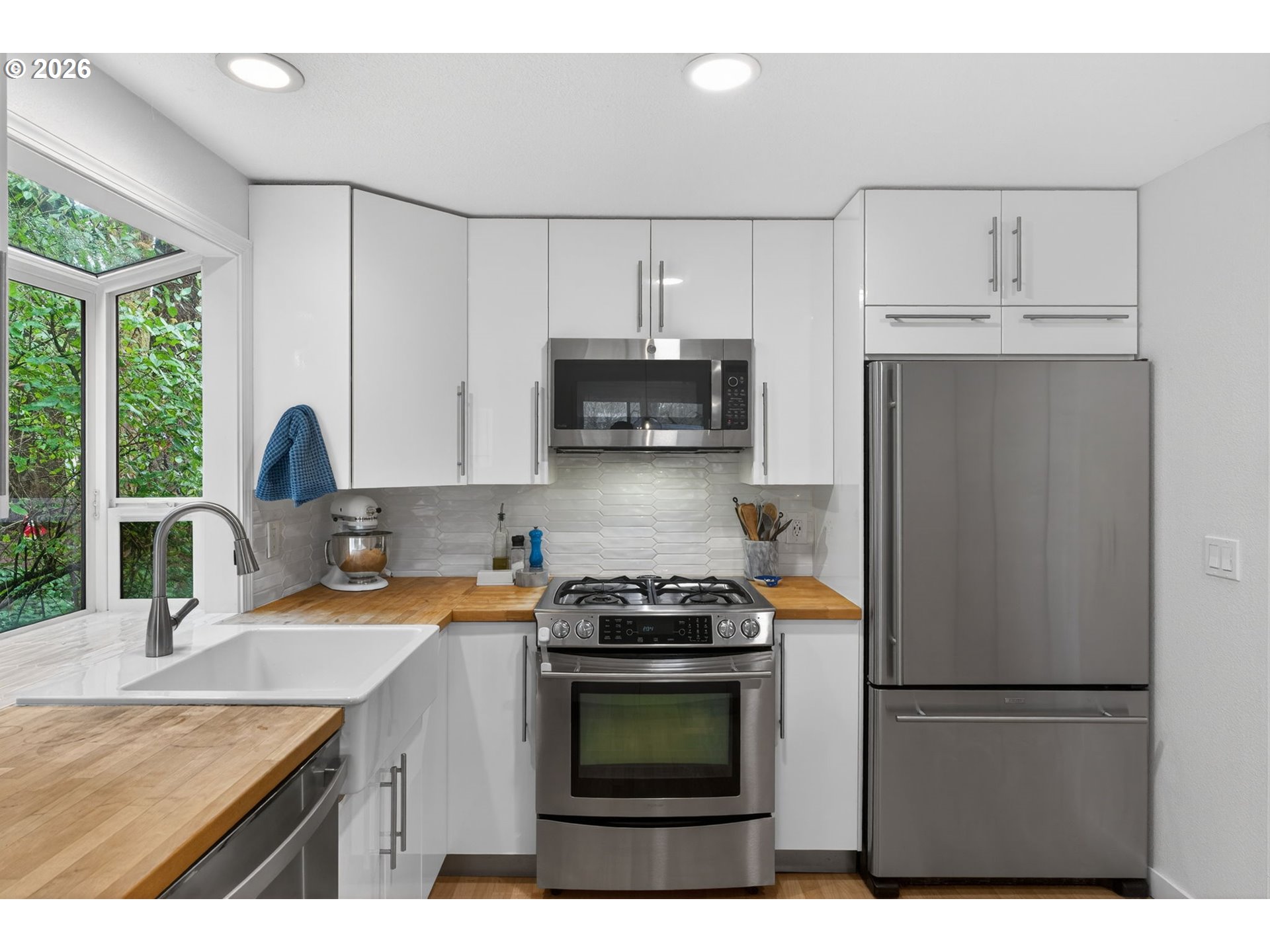 8115 Southwest Hemlock Street Portland, OR 97223 - Photo 10 of 36 a kitchen with stainless steel appliances a stove a sink and a refrigerator