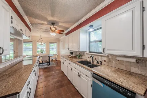 a large white kitchen with a large window