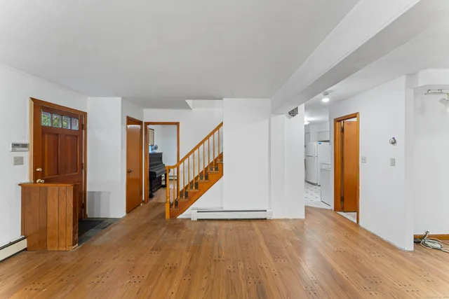a view of an entryway with wooden floor