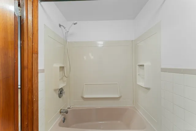 a bathroom with a shower and a bath tub