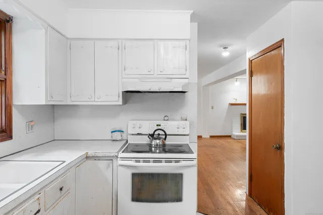 a kitchen with appliances a sink and cabinets