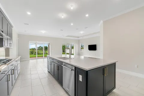 a kitchen with a sink stove and cabinets