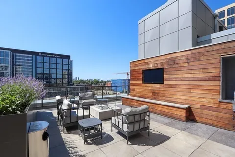 a balcony with furniture and a potted plant
