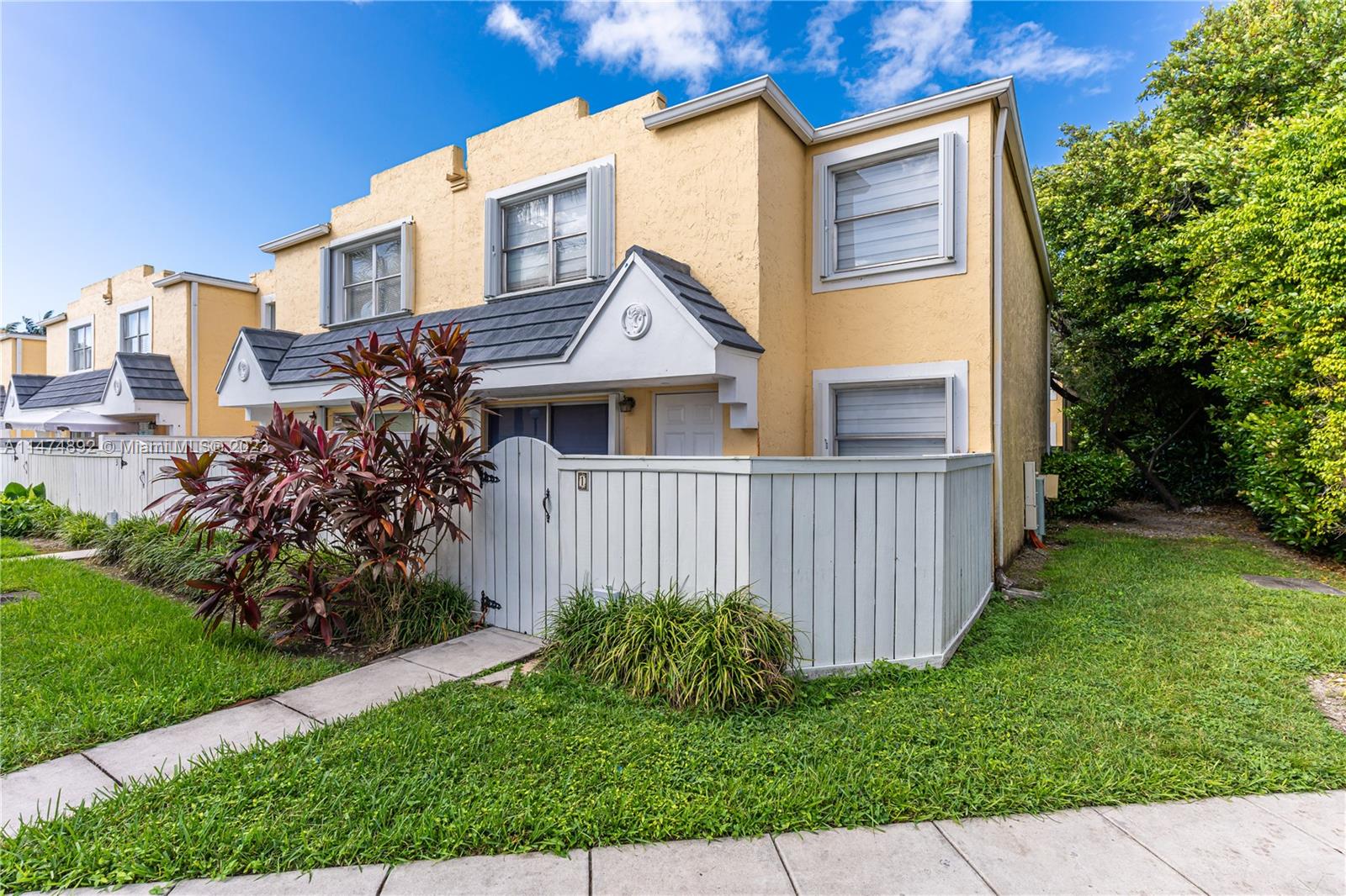 6825 Southwest 45th Lane, Unit 1 Miami, FL 33155 - Photo 1 of 28 a front view of a house with garden