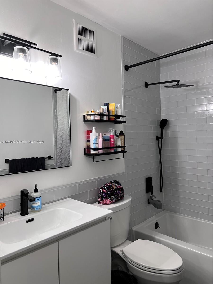 6825 Southwest 45th Lane, Unit 1 Miami, FL 33155 - Photo 12 of 28 a bathroom with a sink a toilet and shower