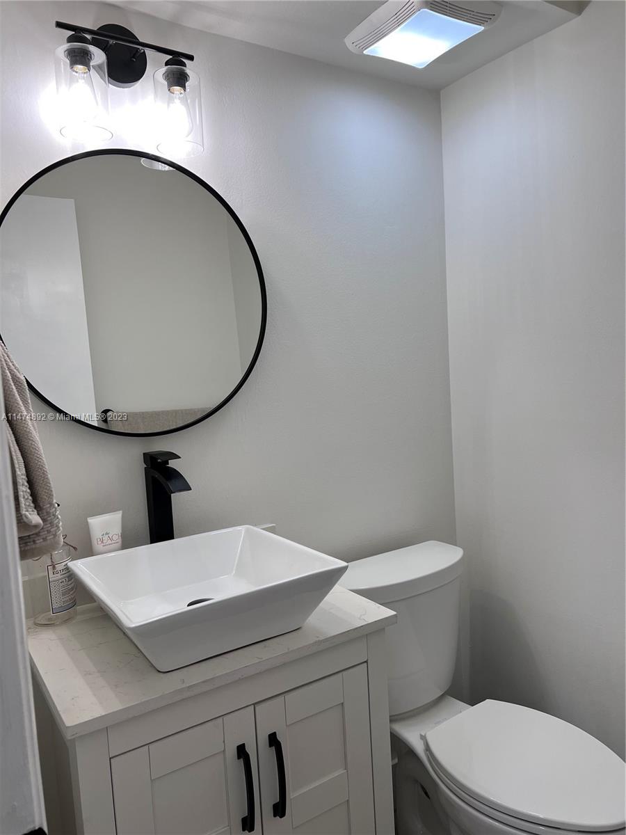 6825 Southwest 45th Lane, Unit 1 Miami, FL 33155 - Photo 13 of 28 a bathroom with a sink and a mirror