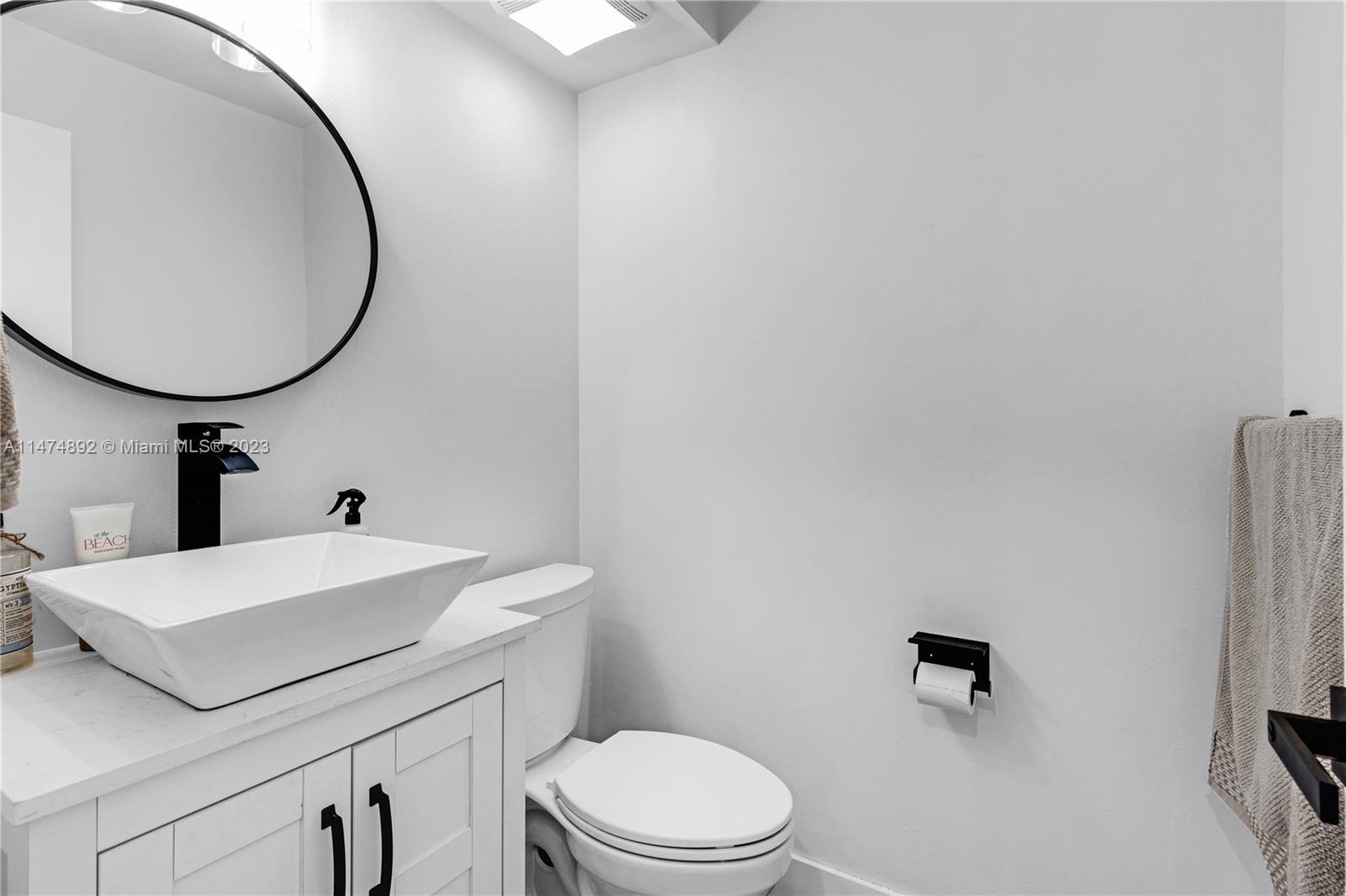 6825 Southwest 45th Lane, Unit 1 Miami, FL 33155 - Photo 16 of 28 a bathroom with a sink a mirror and a toilet
