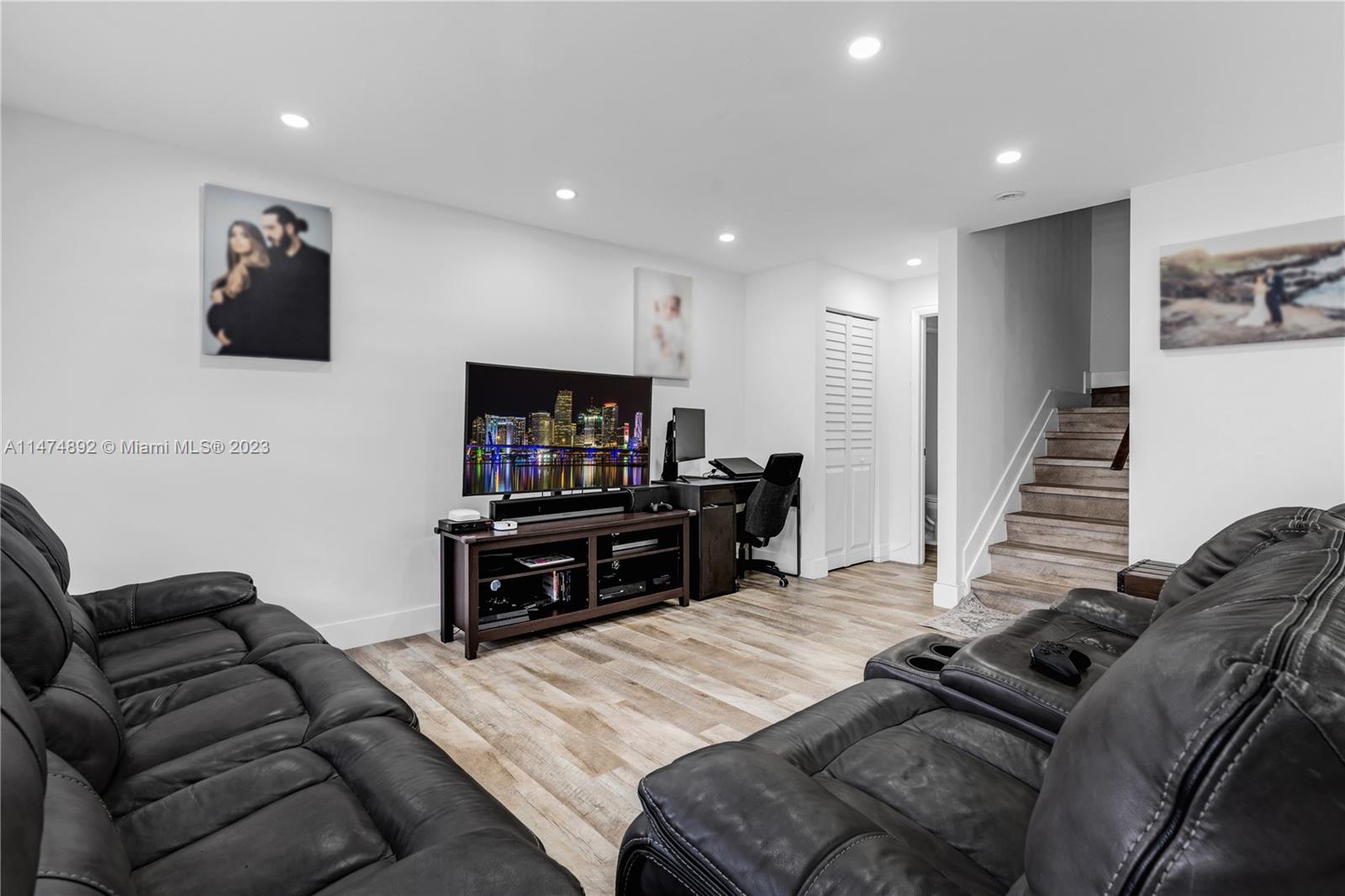 6825 Southwest 45th Lane, Unit 1 Miami, FL 33155 - Photo 5 of 28 a living room with furniture and a flat screen tv