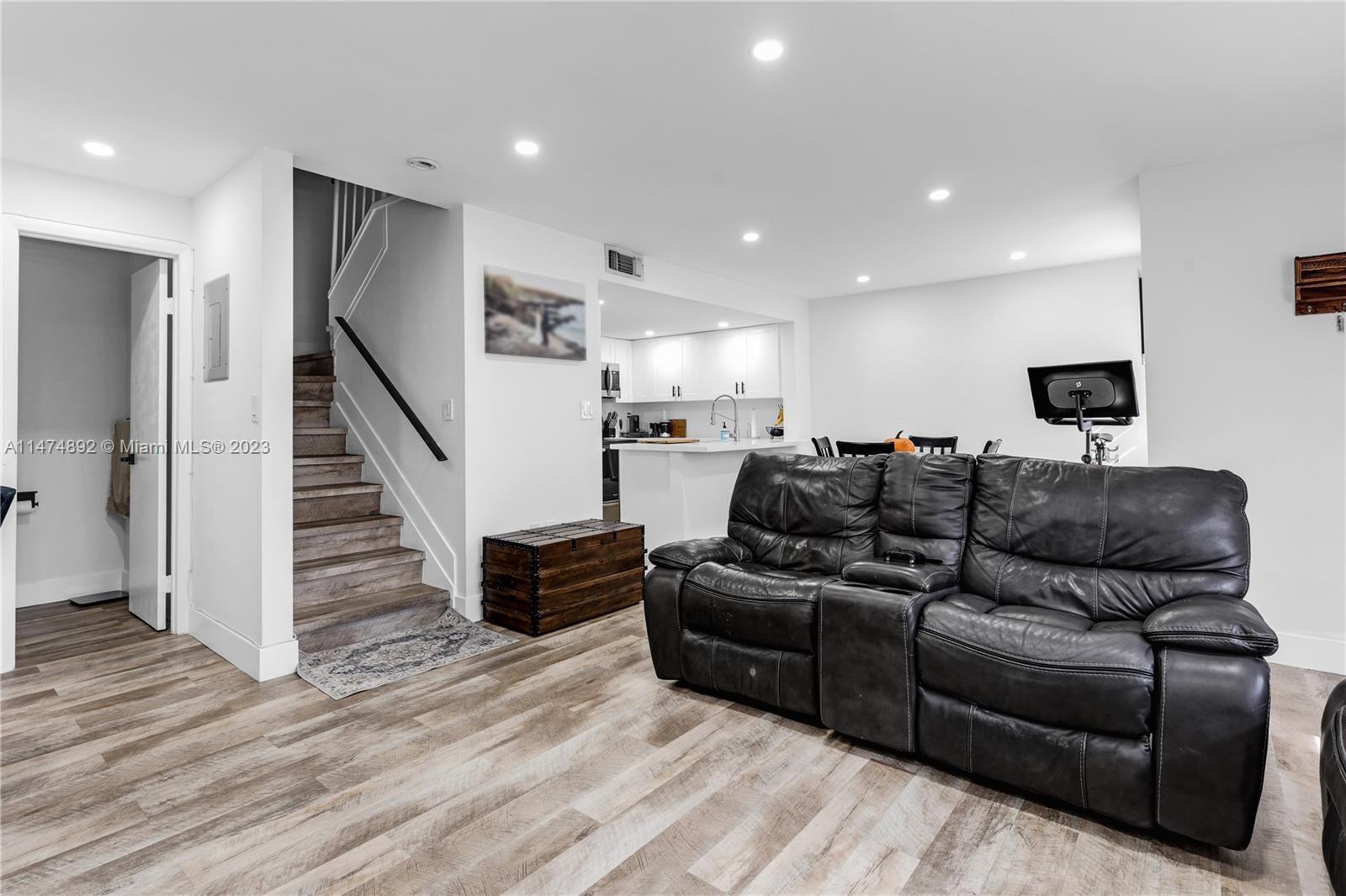 6825 Southwest 45th Lane, Unit 1 Miami, FL 33155 - Photo 6 of 28 a living room with furniture or wooden floor and a flat screen tv
