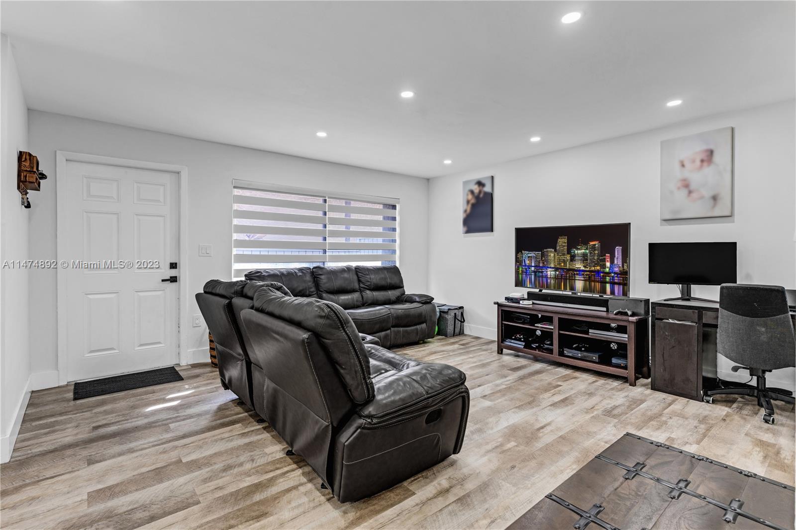 6825 Southwest 45th Lane, Unit 1 Miami, FL 33155 - Photo 8 of 28 a living room with furniture and a flat screen tv
