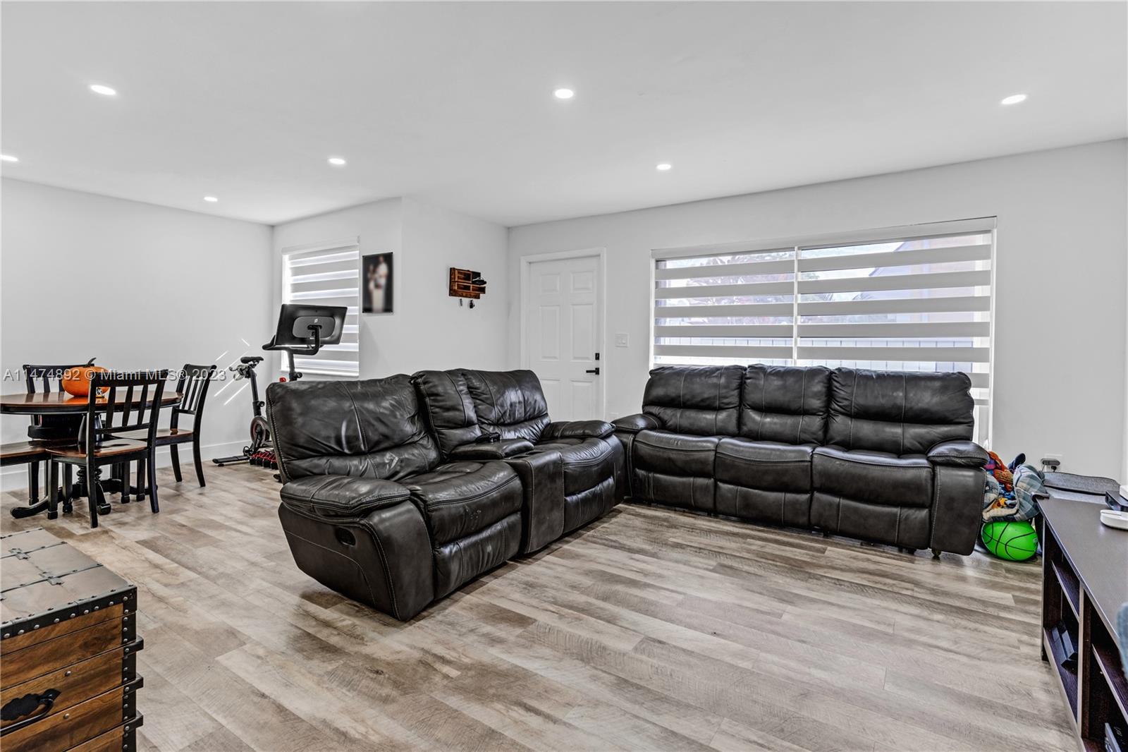 6825 Southwest 45th Lane, Unit 1 Miami, FL 33155 - Photo 9 of 28 a living room with furniture and a wooden floor