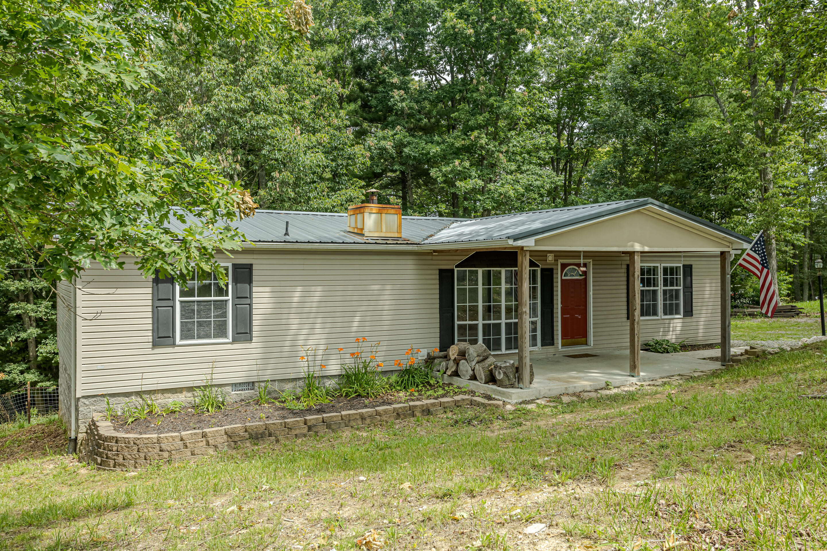 910 Dobbins Hollow Road Riner, VA 24149 - Photo 2 of 35 a front view of a house with a yard