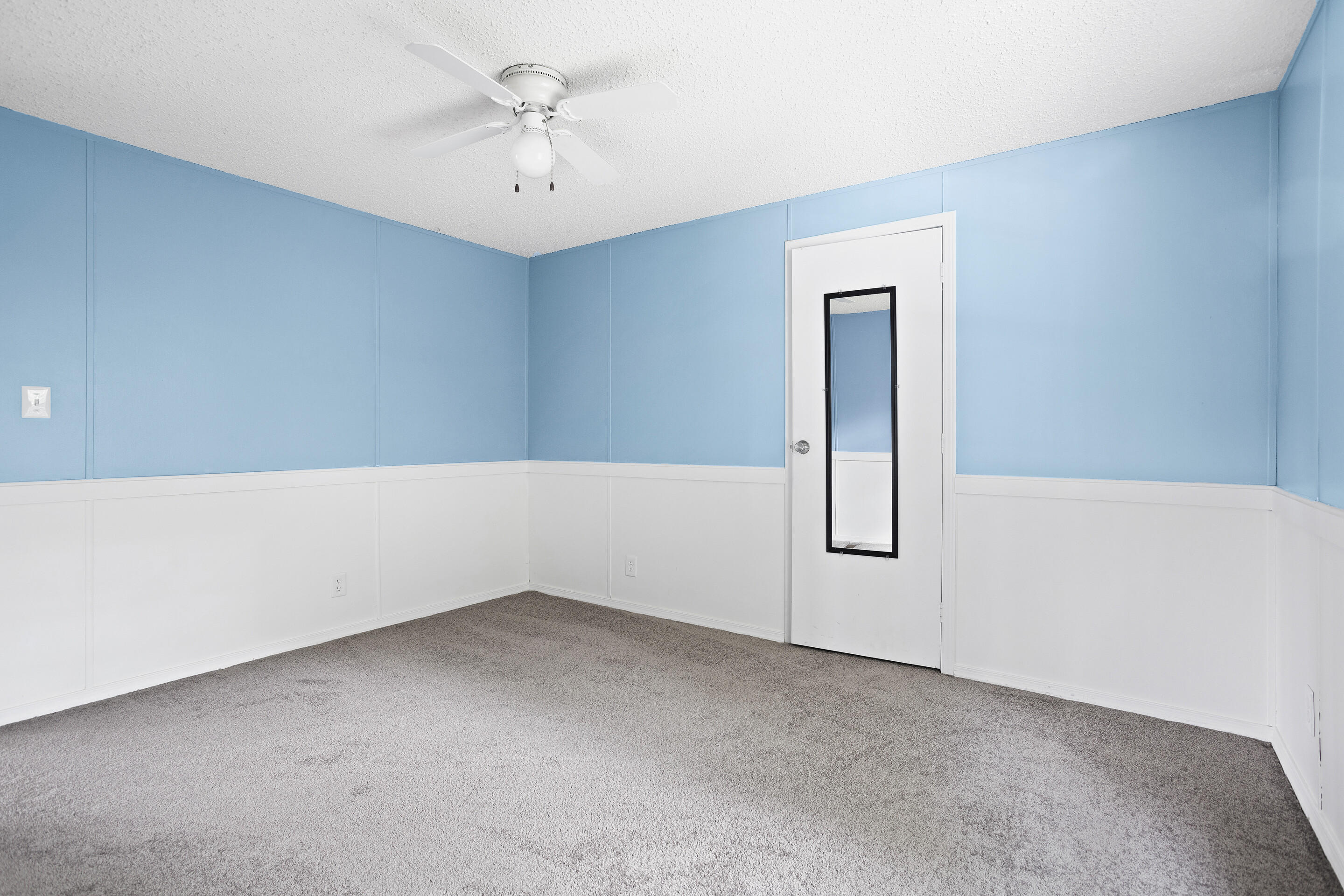 910 Dobbins Hollow Road Riner, VA 24149 - Photo 14 of 35 an empty room with chandelier fan and windows
