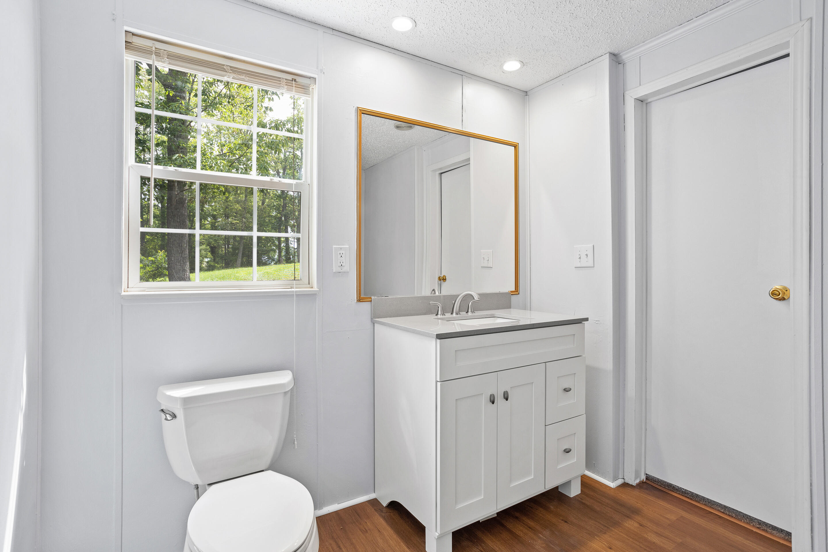 910 Dobbins Hollow Road Riner, VA 24149 - Photo 27 of 35 a bathroom with a toilet a sink and a mirror