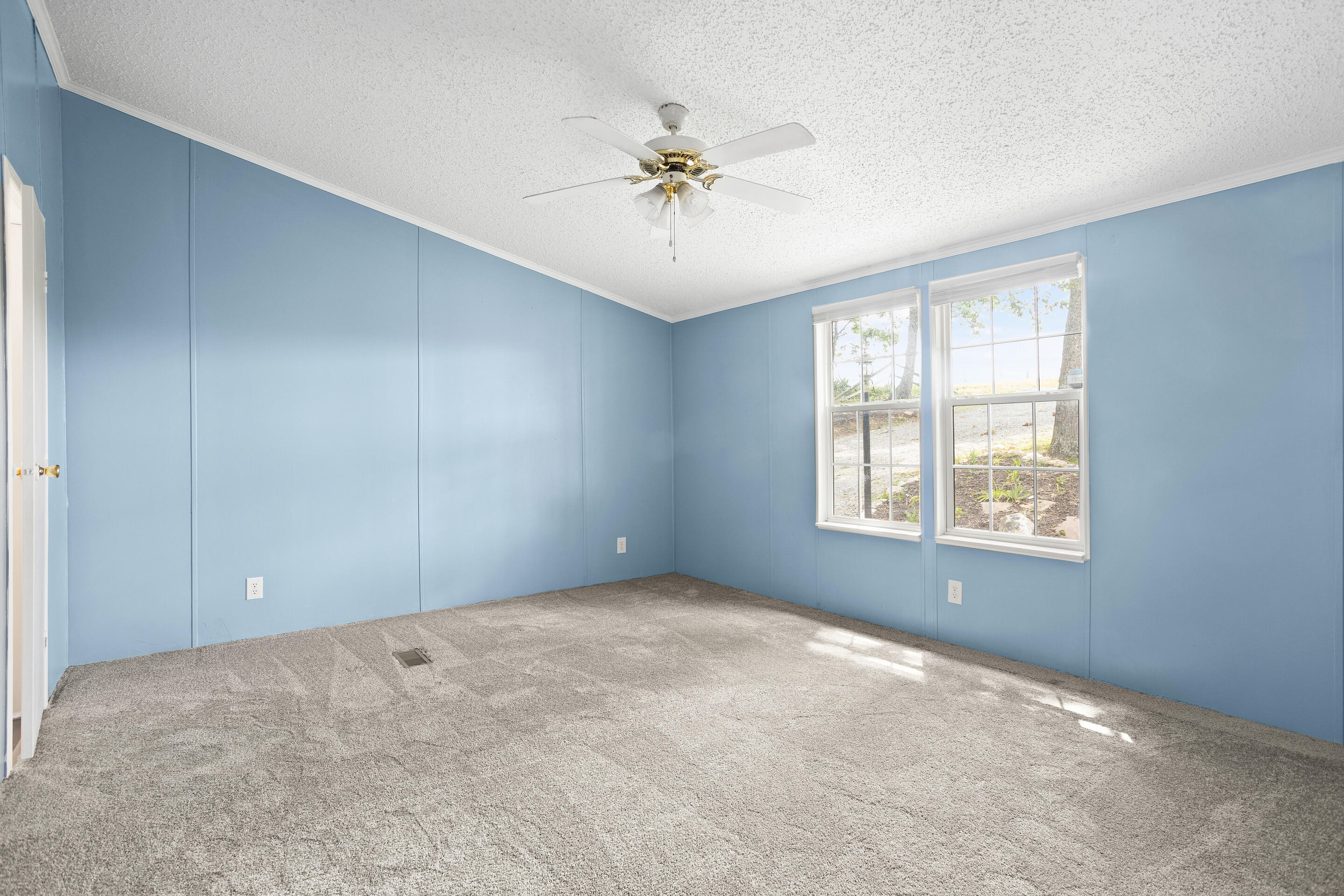 910 Dobbins Hollow Road Riner, VA 24149 - Photo 28 of 35 an empty room with fan and windows