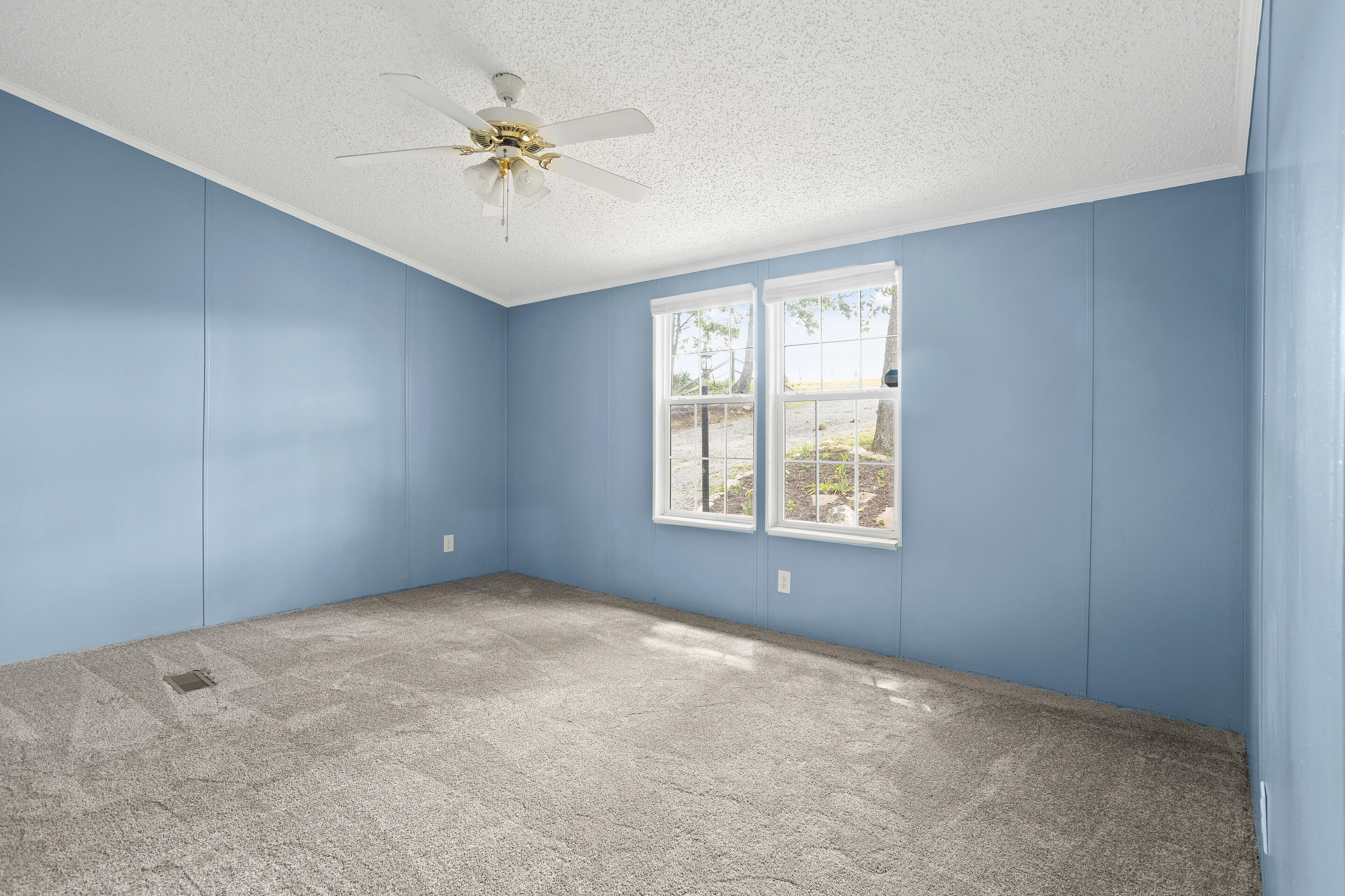 910 Dobbins Hollow Road Riner, VA 24149 - Photo 29 of 35 an empty room with a ceiling fan and window
