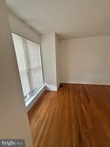 an empty room with wooden floor and door