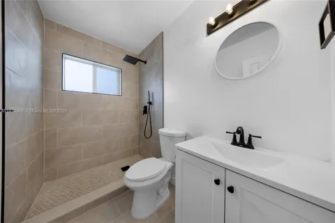 a white toilet sitting next to a bathroom sink