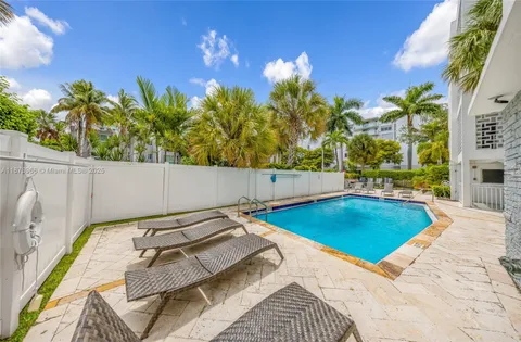 a view of swimming pool with a lounge chairs