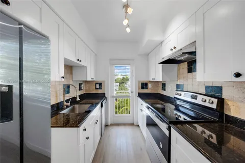 a kitchen with stainless steel appliances granite countertop a stove and a microwave