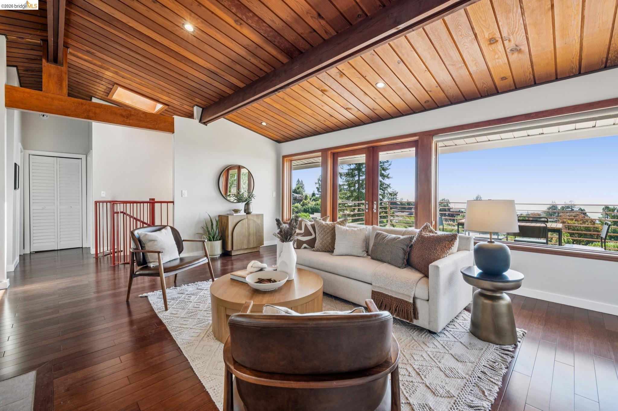 1394 Queens Road Berkeley, CA 94708 - Photo 7 of 63 Vaulted wood-paneled ceilings with exposed beams, wood-finish flooring, and expansive windows