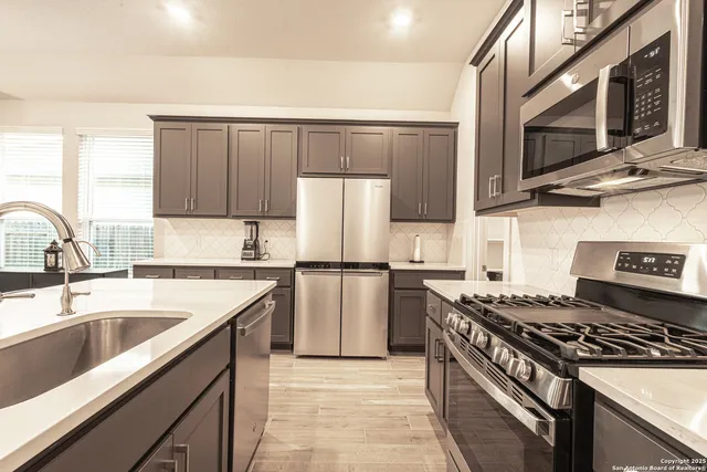 a kitchen with a sink stove and refrigerator
