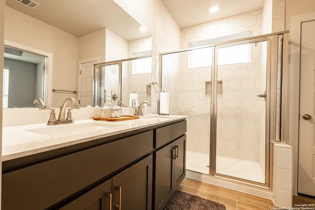 a bathroom with a double vanity sink and a mirror
