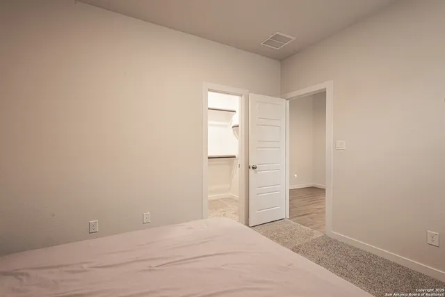 a view of an empty room and closet