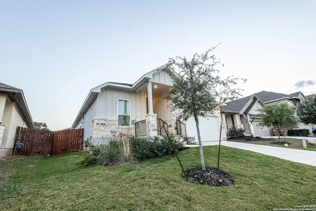 a house that has a tree in front of it