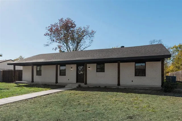 a house that has a tree in front of it