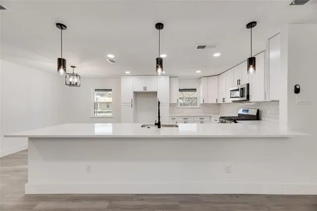 wooden floor in an empty room with a ceiling fan