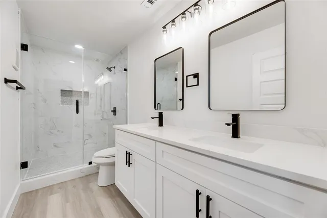 a kitchen with kitchen island white cabinets and refrigerator