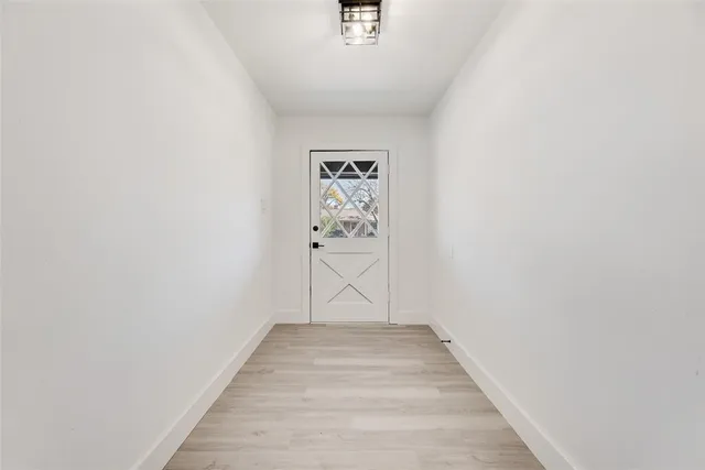 a view of room with wooden floor