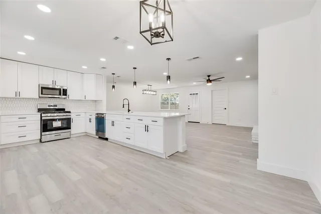 a view of backyard with wooden fence and large trees