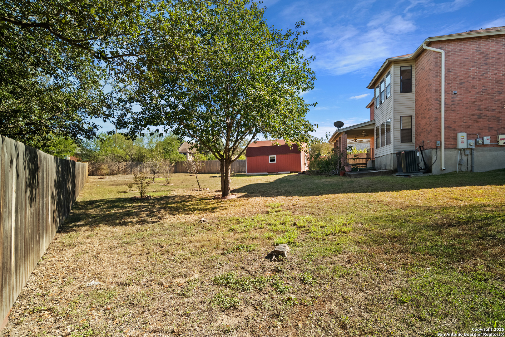 7723 Red River Bay Converse, TX 78109 - Photo 14 of 16 a view of a yard with a house and a large tree