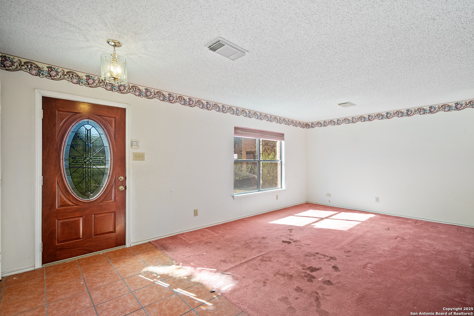 7723 Red River Bay Converse, TX 78109 - Photo 2 of 16 wooden floor in an empty room with a window