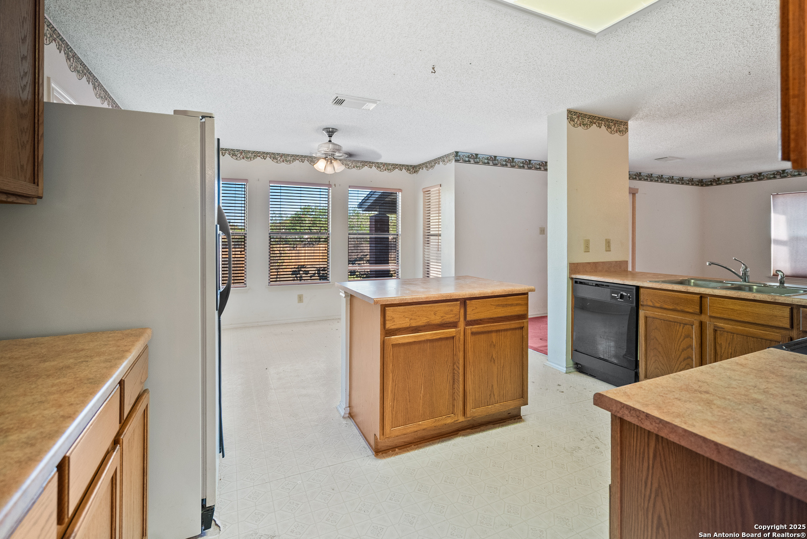 7723 Red River Bay Converse, TX 78109 - Photo 6 of 16 a kitchen with stainless steel appliances granite countertop a refrigerator a stove and a sink