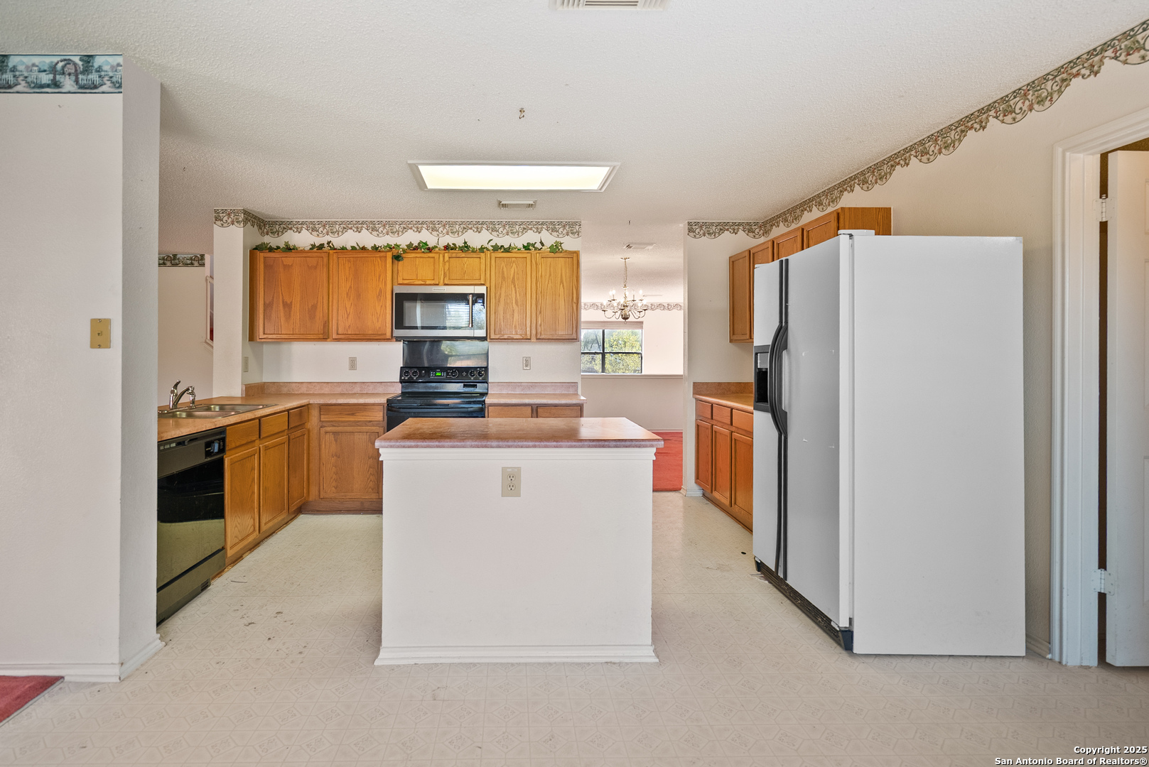 7723 Red River Bay Converse, TX 78109 - Photo 7 of 16 a kitchen with a refrigerator stove and sink