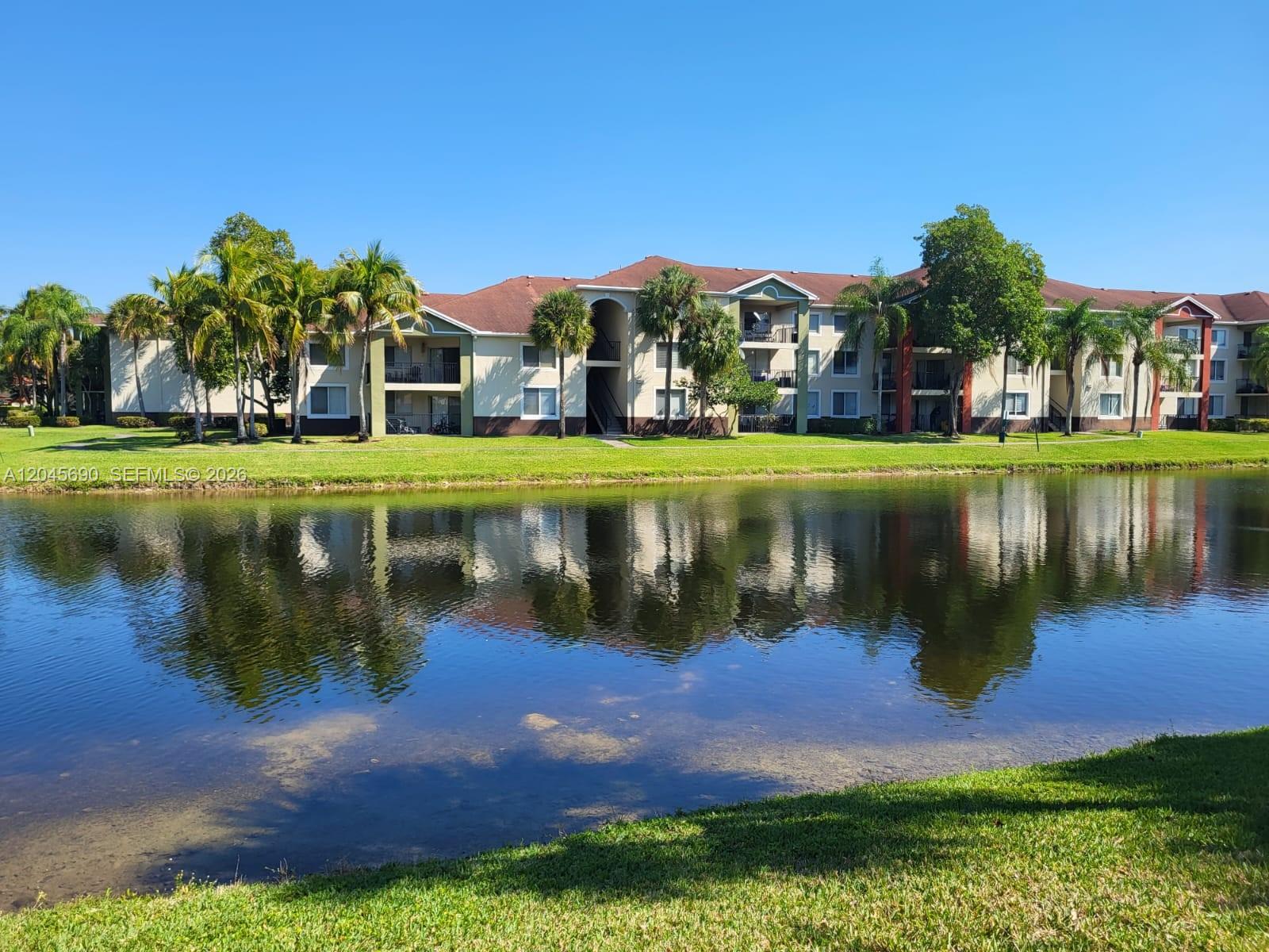 8070 North Nob Hill Road, Unit 208 Tamarac, FL 33321 - Photo 15 of 16 a view of a house with a yard
