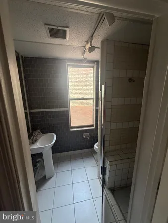 a view of a livingroom with wooden floor and kitchen space