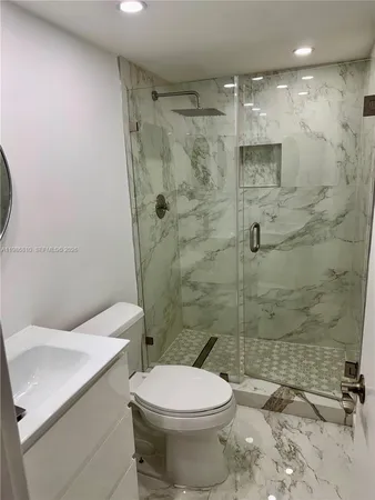 a bathroom with a toilet sink and shower