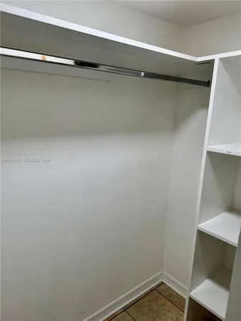 a view of a room with shelf on the wall