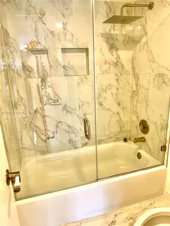 a bathroom with a bathtub and a shower